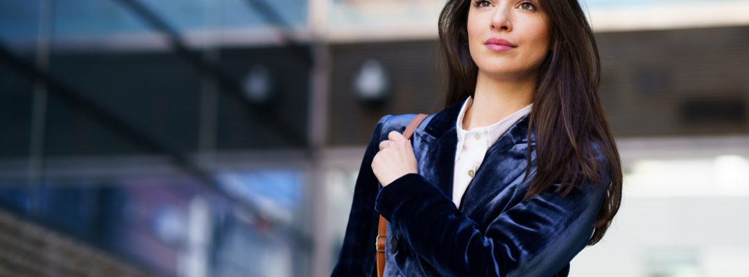 business-woman-wearing-blue-suit-outside-an-office-2AWRB9M